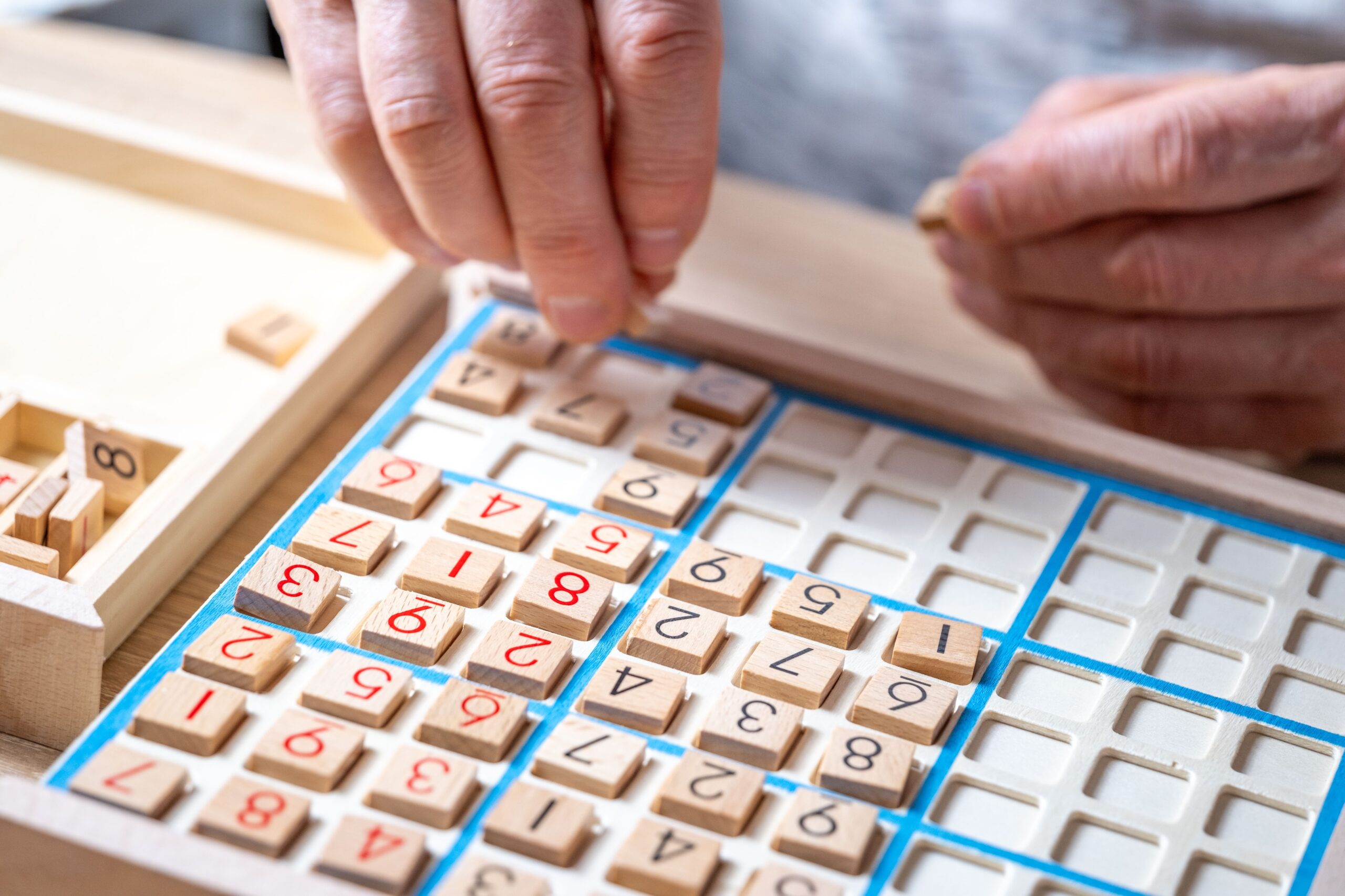 Close-up,Hands,Carefully,Placing,Number,Into,Sudoku,Puzzle,,Elderly,Person Cognitive Rehabilitation
